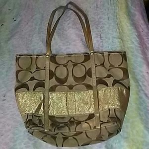 Coach purse in gold and tan color